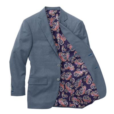 A suit jacket with a paisley pattern on the inside of it.