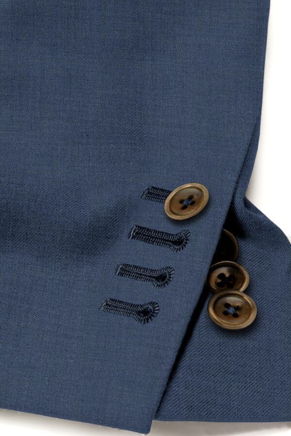 A close up of buttons on a suit jacket