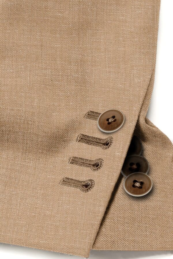 A close up of buttons on the side of a suit jacket.