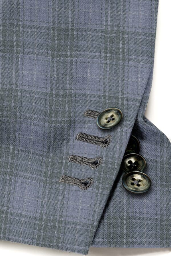 A close up of buttons on a suit jacket