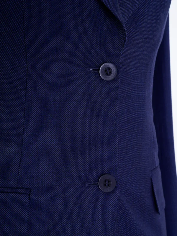 A close up of the buttons on a suit jacket.