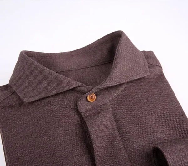 A close up of the collar on a brown shirt