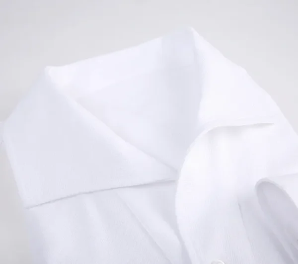 A white shirt is folded and has some folds.