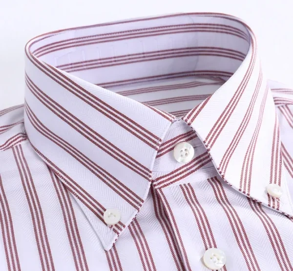 A close up of the collar and button on a shirt