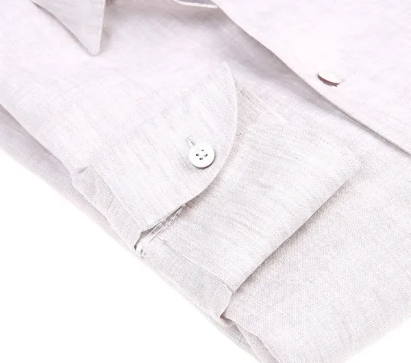 A close up of the buttons on a white shirt