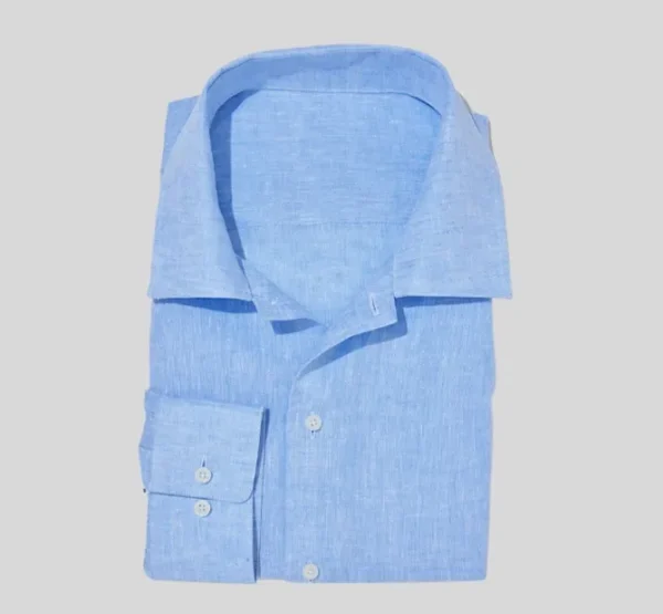 A blue shirt is folded and has no buttons.