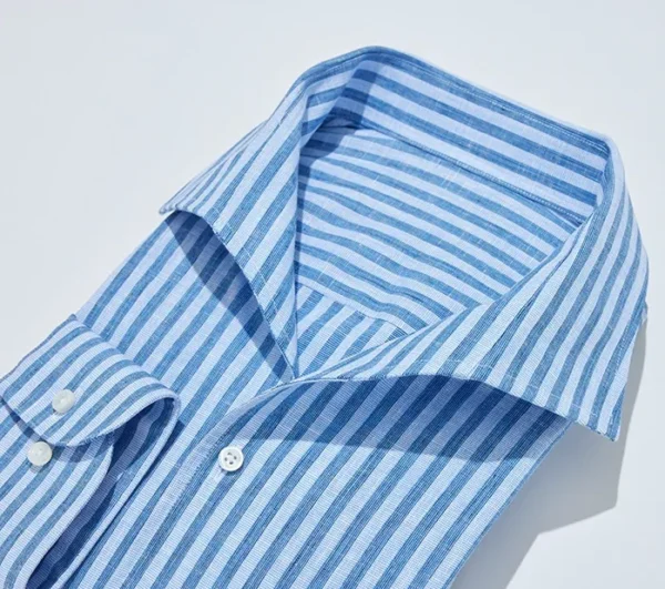 A blue striped shirt is folded on the table.