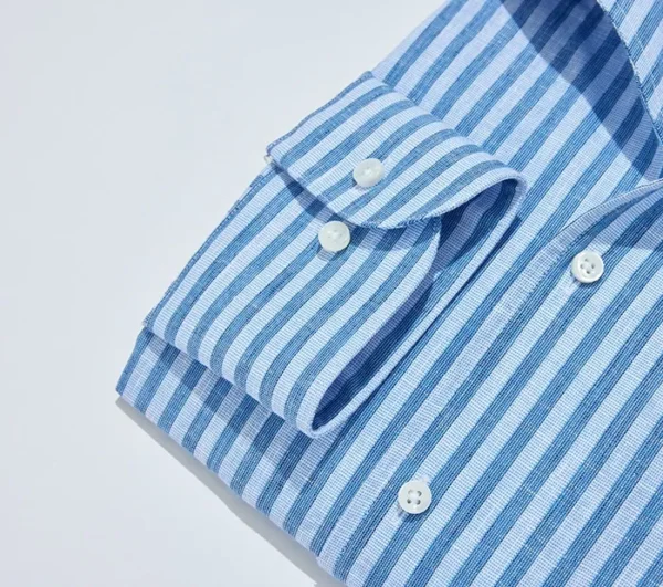 A close up of the collar and buttons on a shirt.