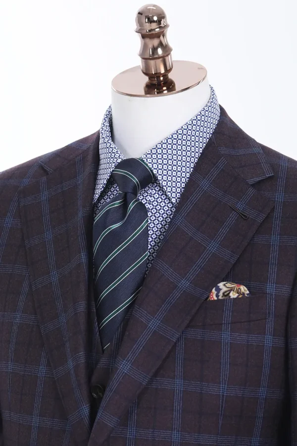 A suit and tie with a blue plaid jacket.