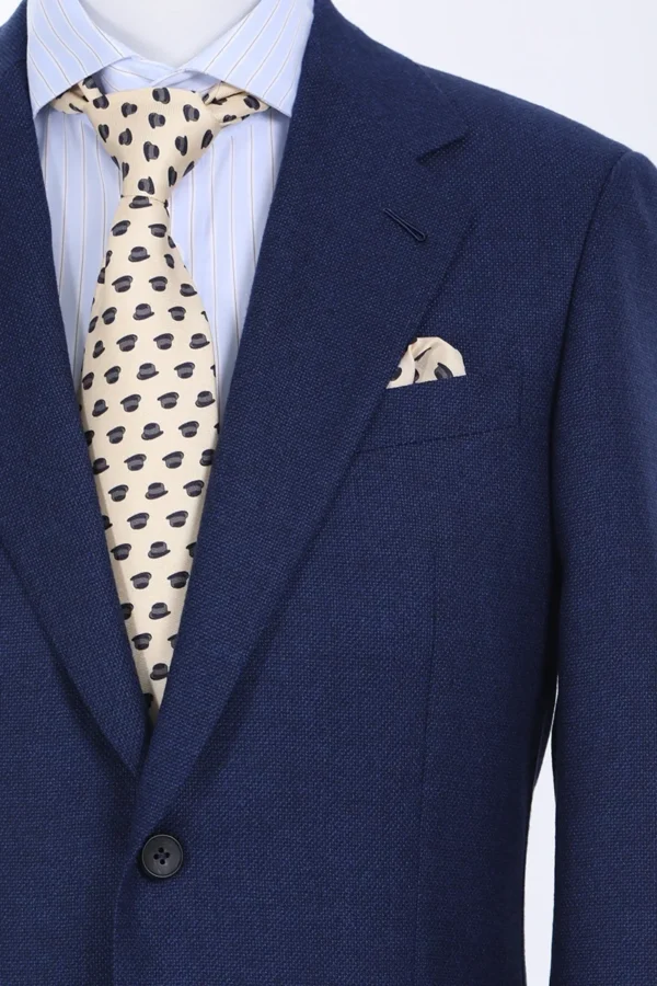 A man in a suit and tie with a polka dot tie.