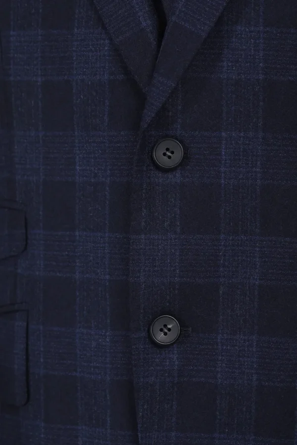 A button on the chest of a suit jacket.