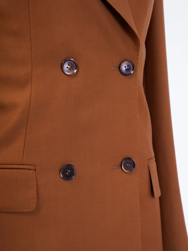 A close up of the buttons on a brown jacket.