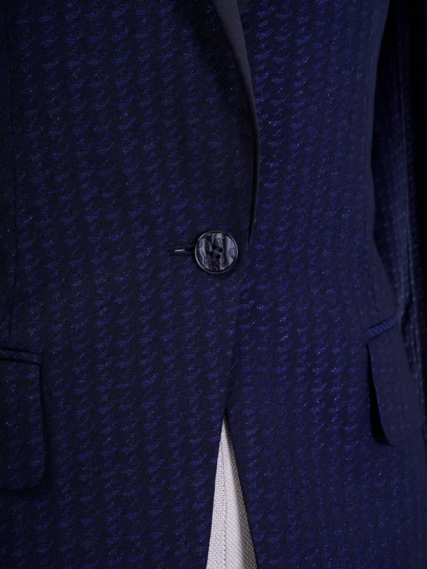 A close up of the button on a suit jacket