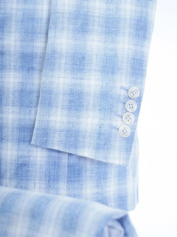 A close up of buttons on a blue plaid suit