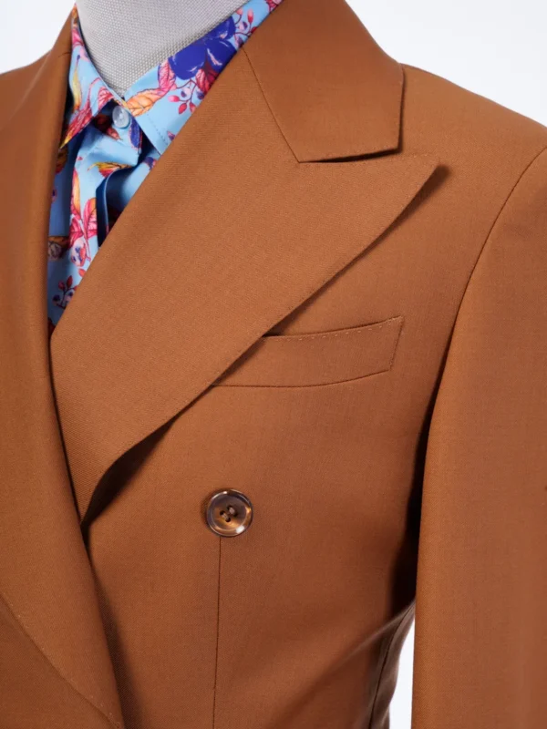 A man in brown suit and tie with a floral print shirt.