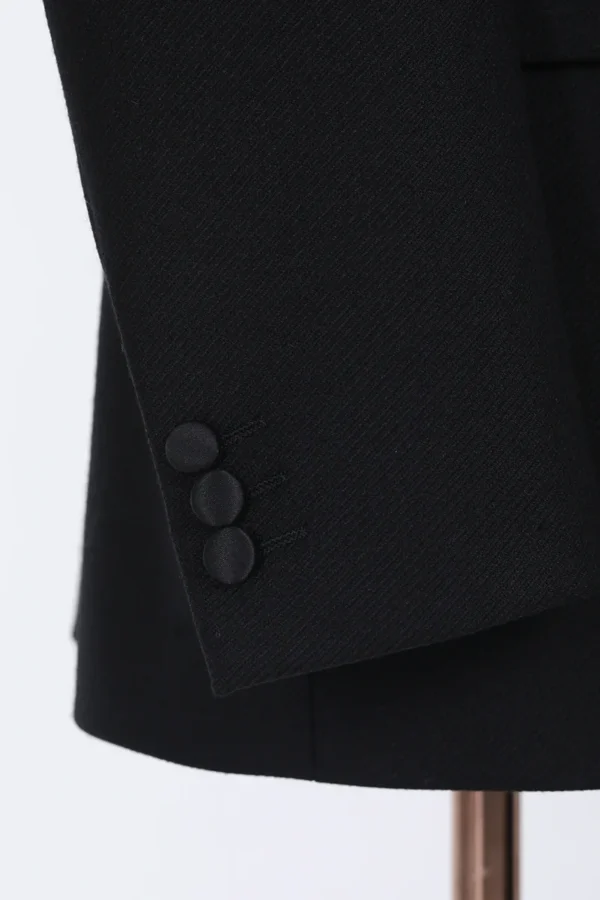 A close up of buttons on the sleeve of a suit