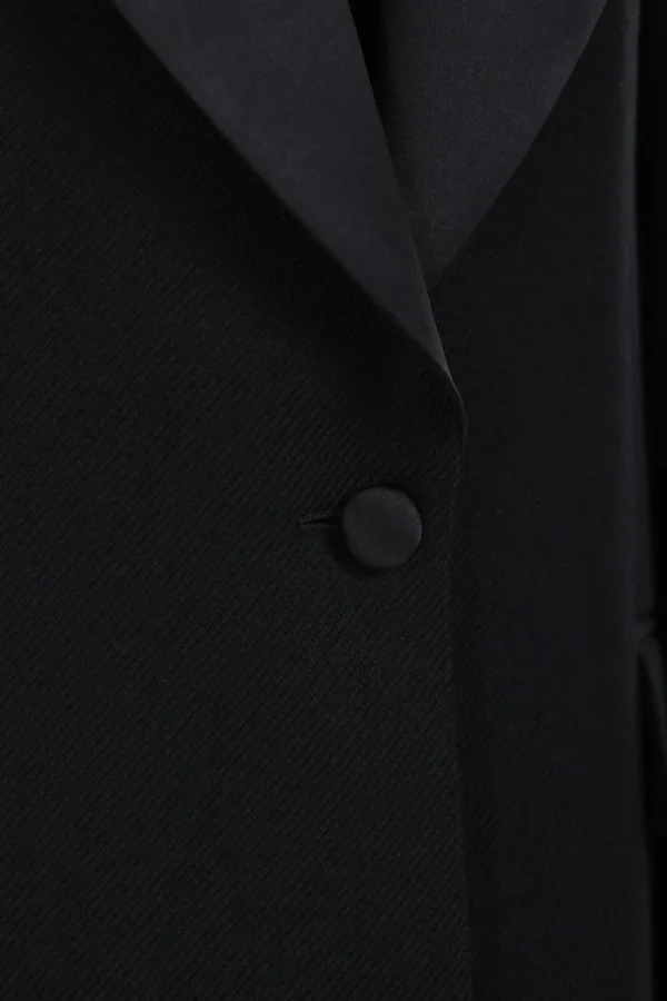 A black suit jacket with buttons on the lapel.