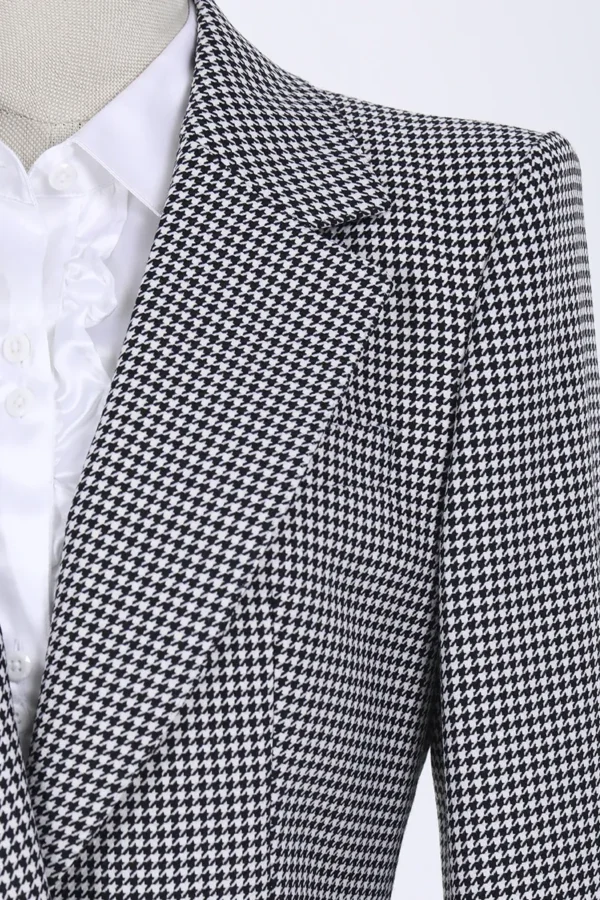 A close up of the jacket and shirt on a man.