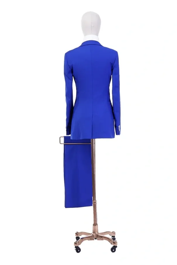 A mannequin wearing blue is standing in front of a dress.