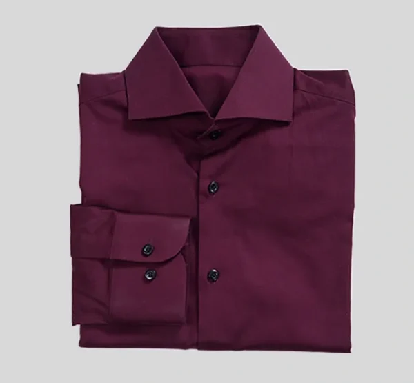 A maroon colored shirt is shown on a gray background.