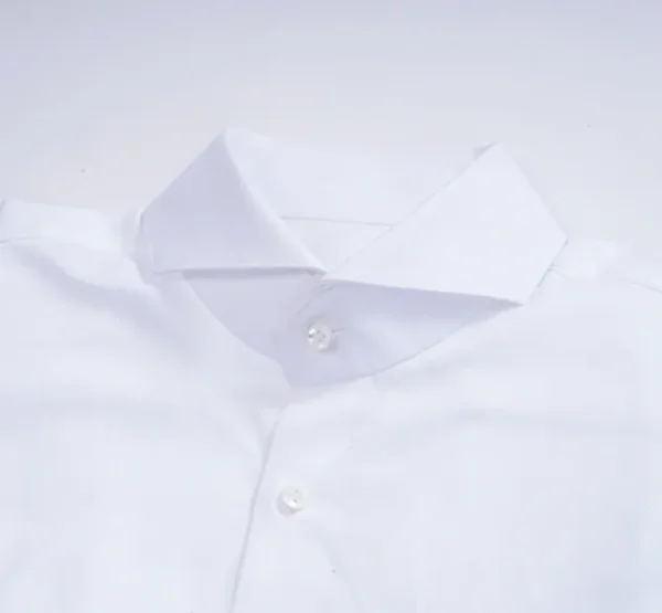 A white shirt with a button down collar and a diamond shaped design.