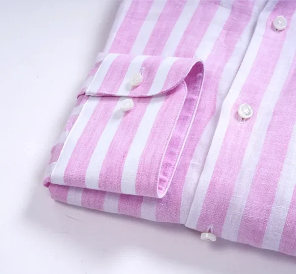 A close up of the sleeve and button on a shirt