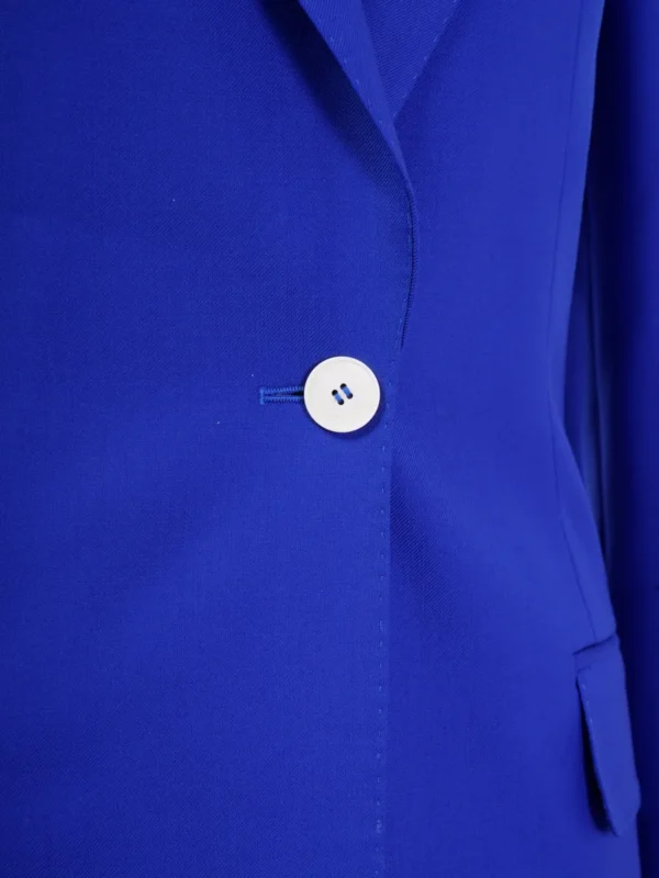 A close up of the button on a blue jacket.