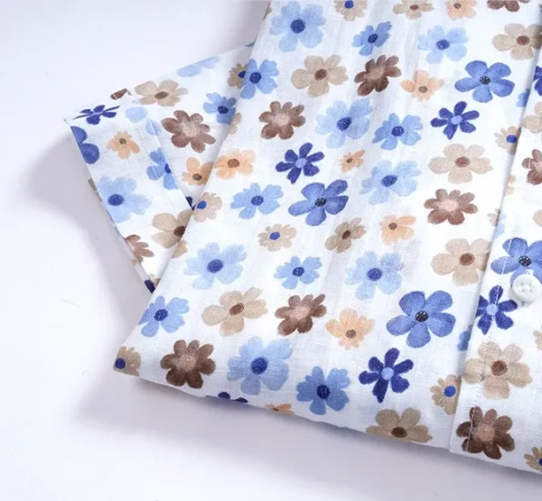 A close up of a sheet with flowers on it