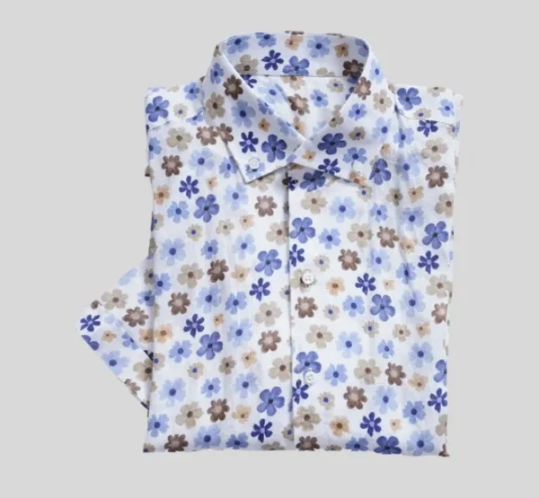 A white shirt with blue and brown flowers on it.