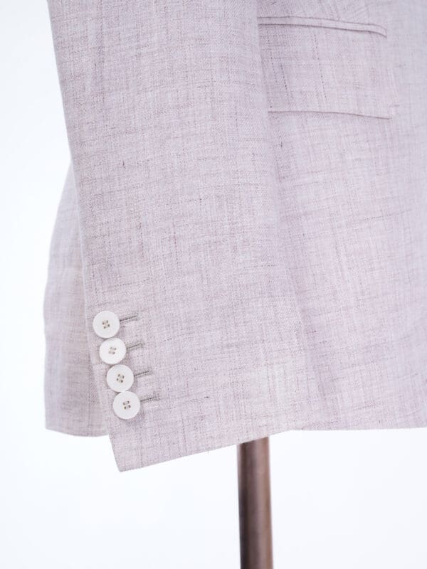 A close up of the buttons on a suit jacket