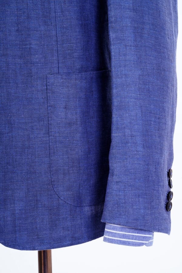 A close up of the pocket on a blue suit