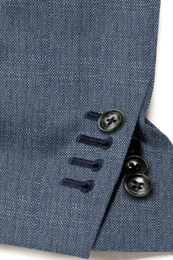 A close up of buttons on a suit jacket