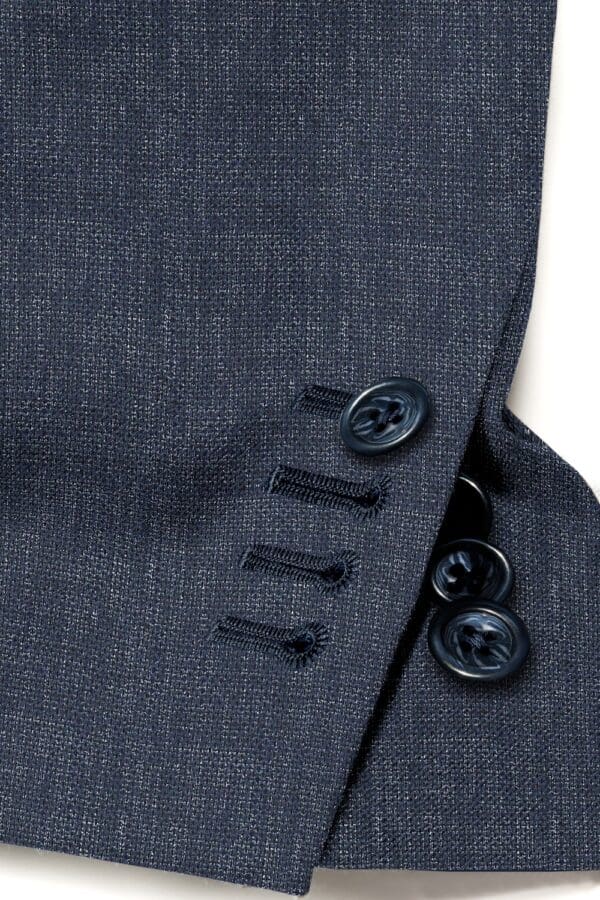 A close up of buttons on the side of a suit jacket.