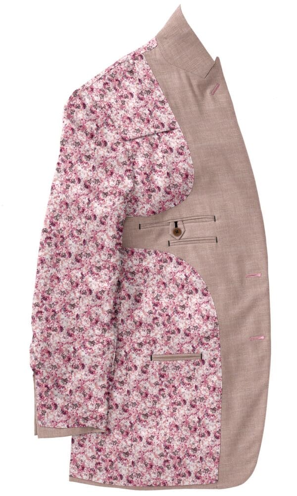 A pink floral print suit jacket and brown pants.